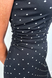 Close-up of an asymmetrical polka dot midi dress