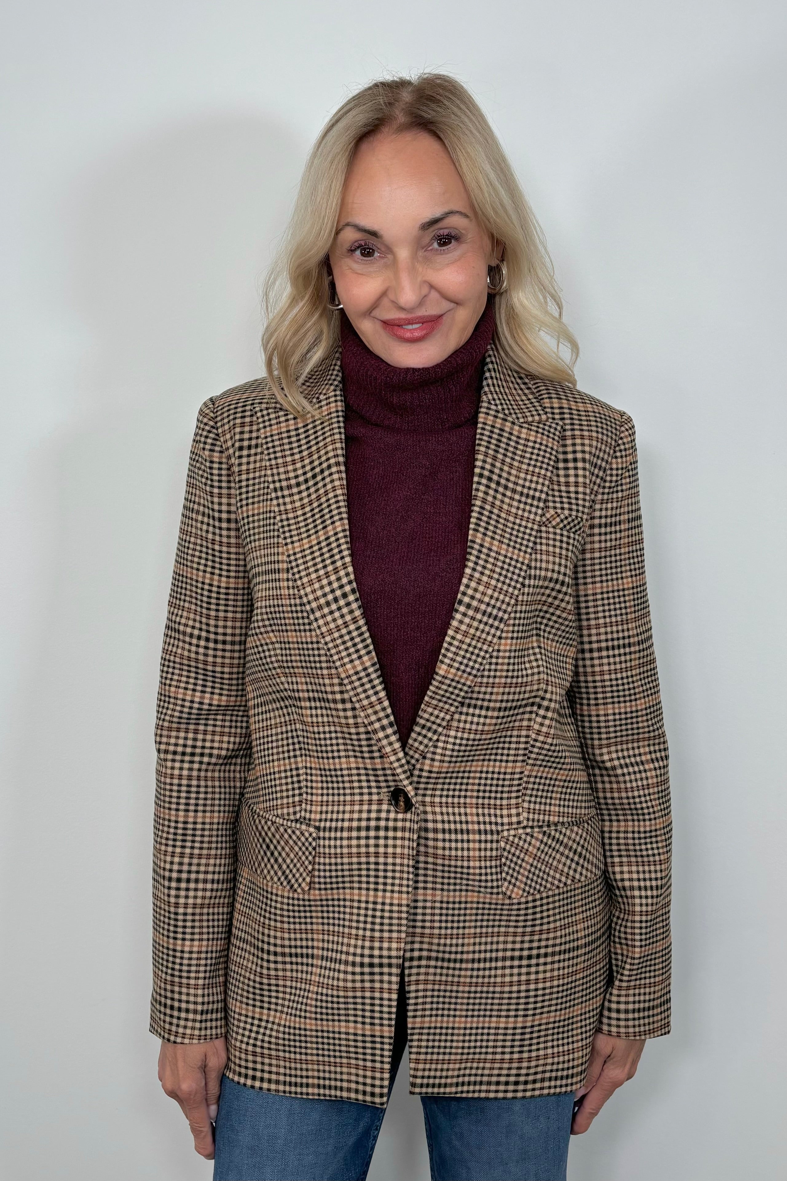 Front view of woman wearing a plaid blazer