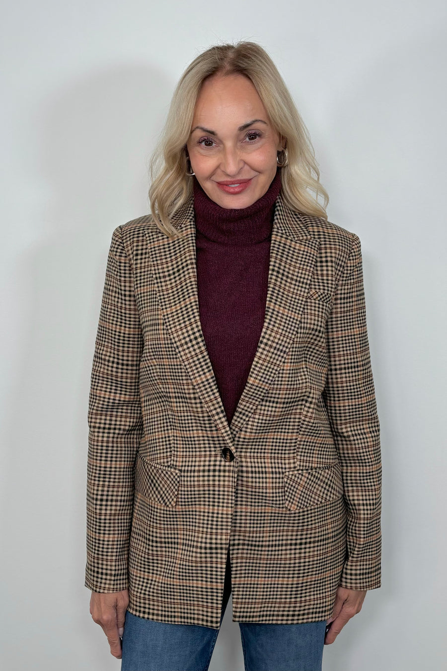 Front view of woman wearing a plaid blazer