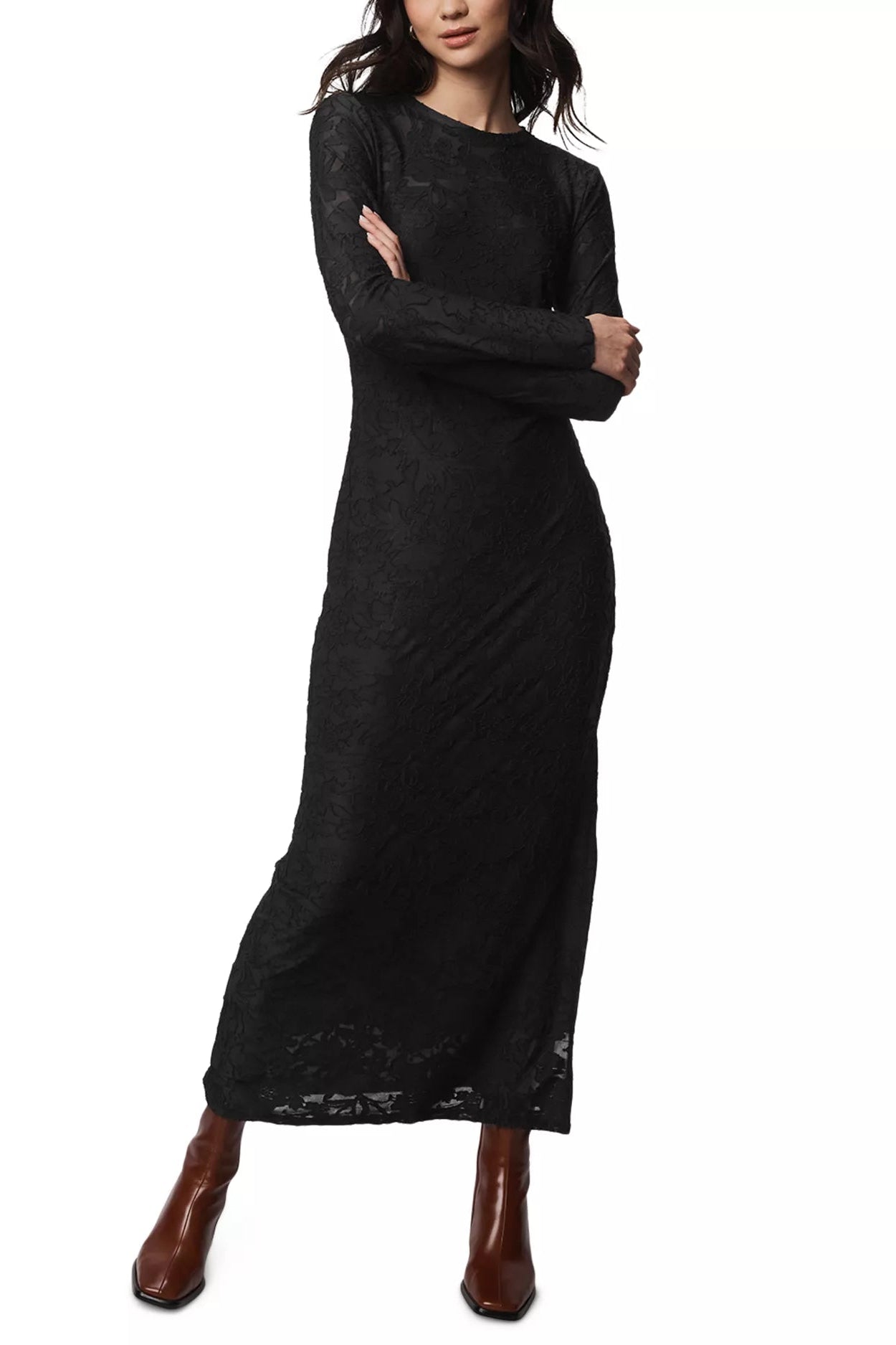 Woman wearing a black long-sleeve dress with lace details on a white background