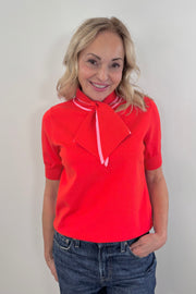 Woman wearing a bright red neck tie top