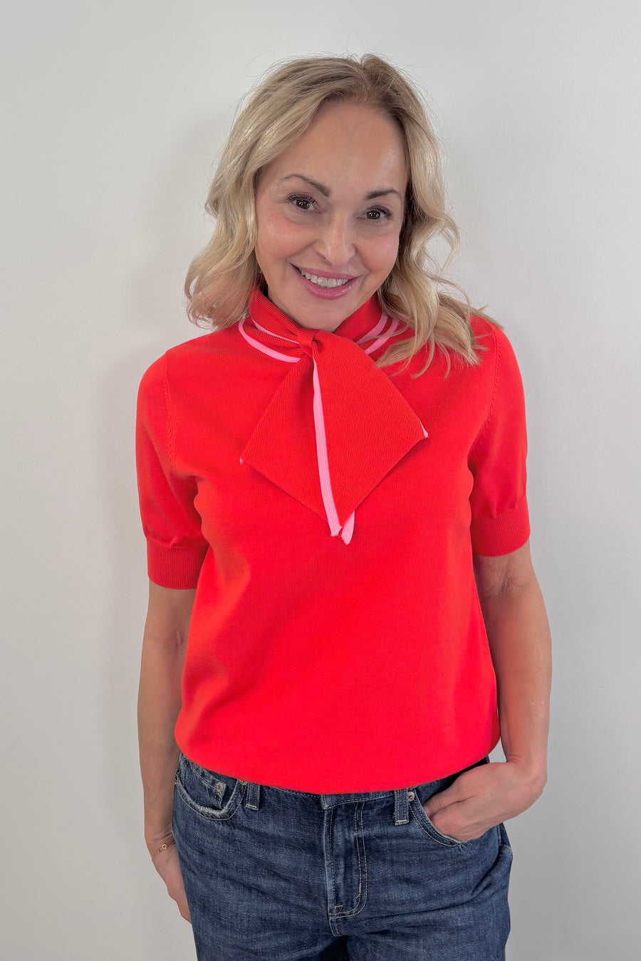 Woman wearing a bright red neck tie top
