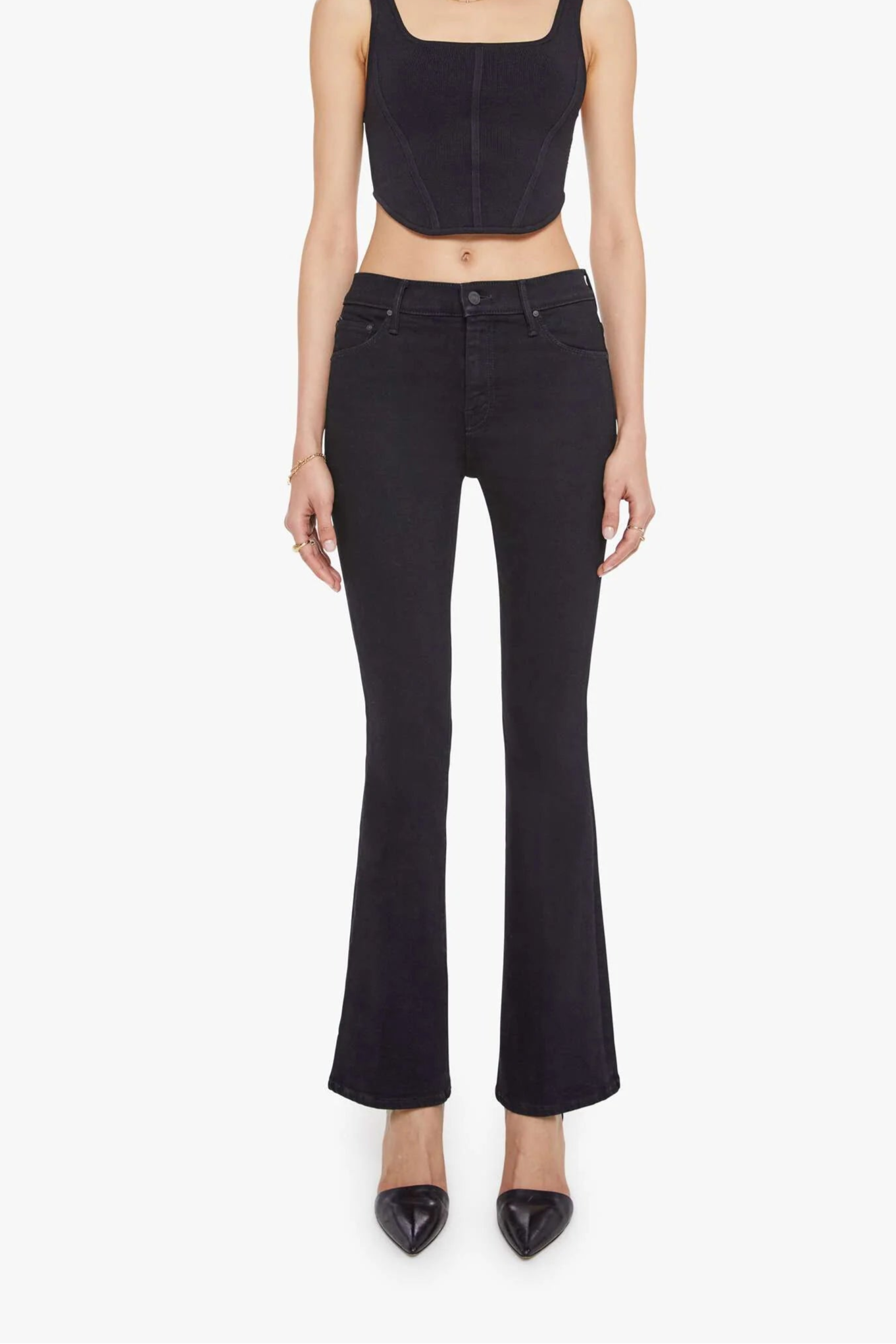 Front view of woman wearing black fitted jeans with a flare