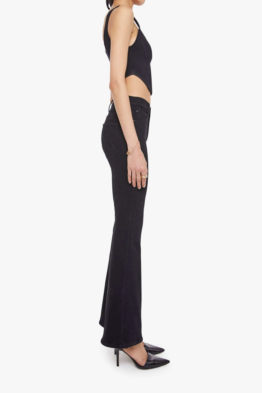 Side view of woman wearing black fitted jeans with a flare