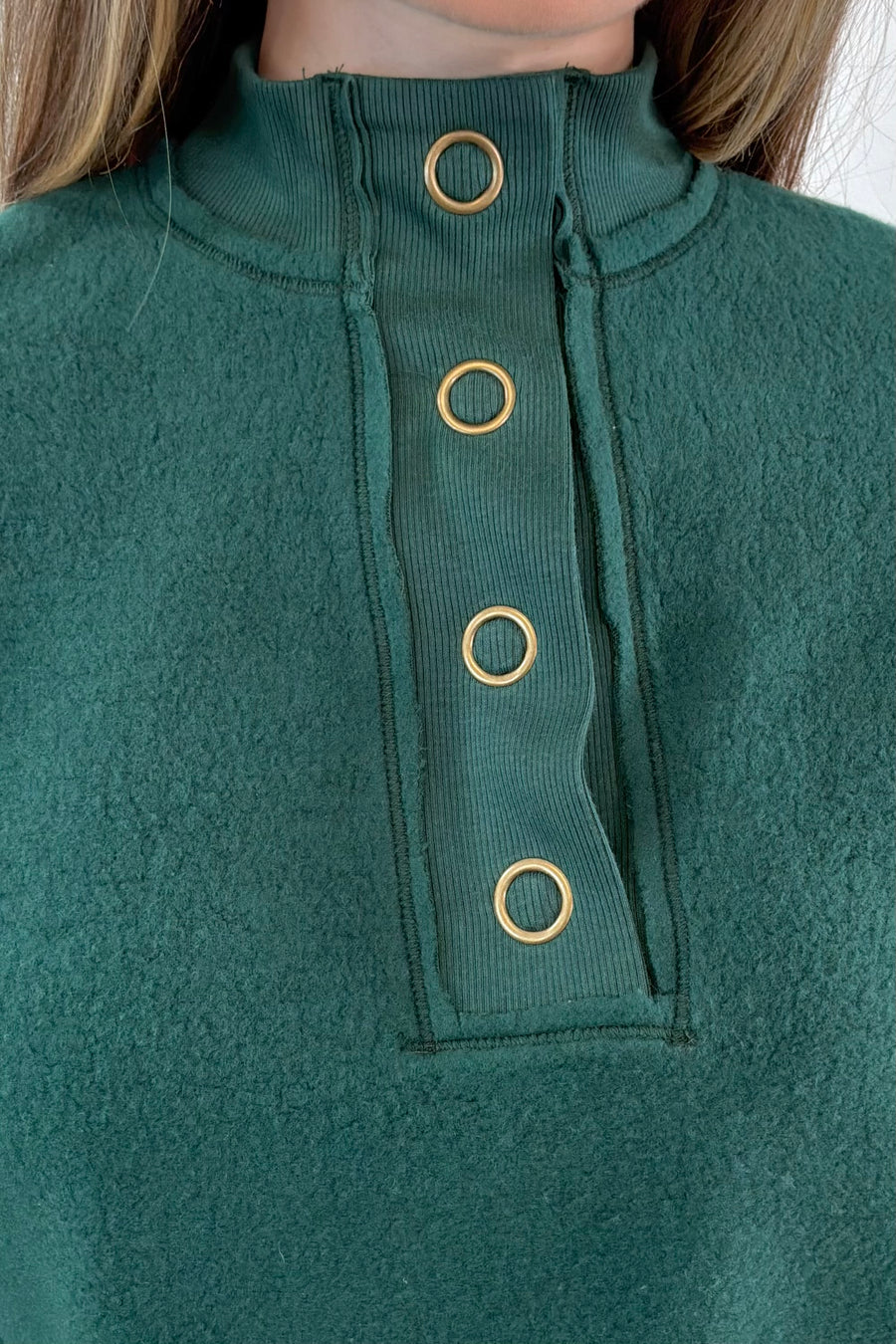 close-up of a green fleece Henley sweatshirt