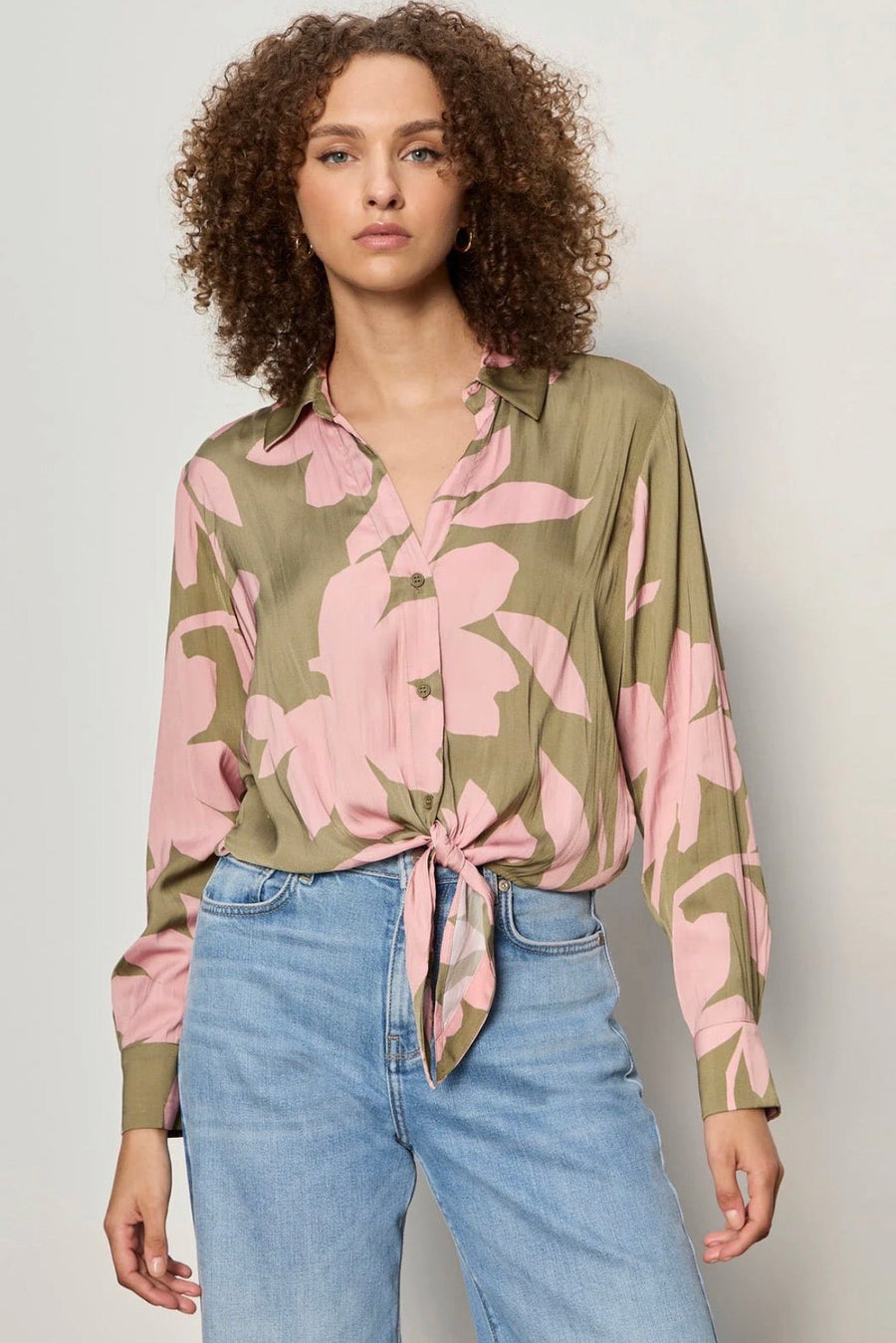 Close up of Woman wearing a dark green and pink printed top