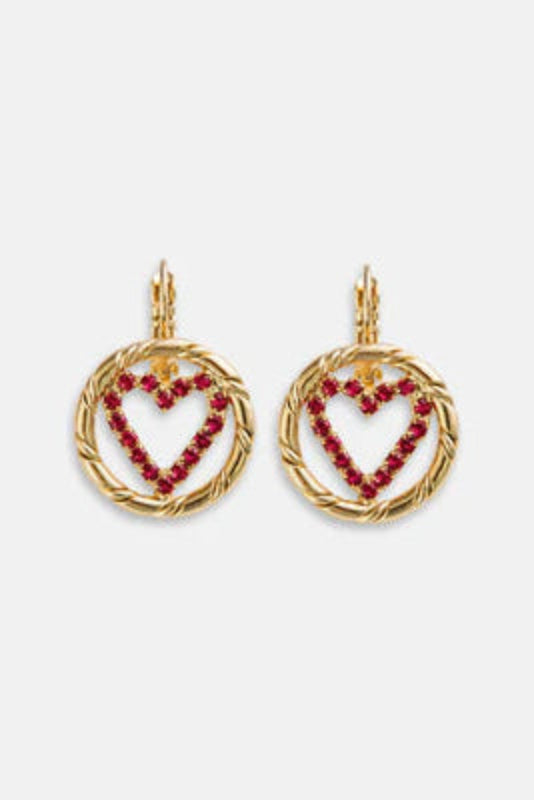 Heart-shaped earrings with red stones on a white background