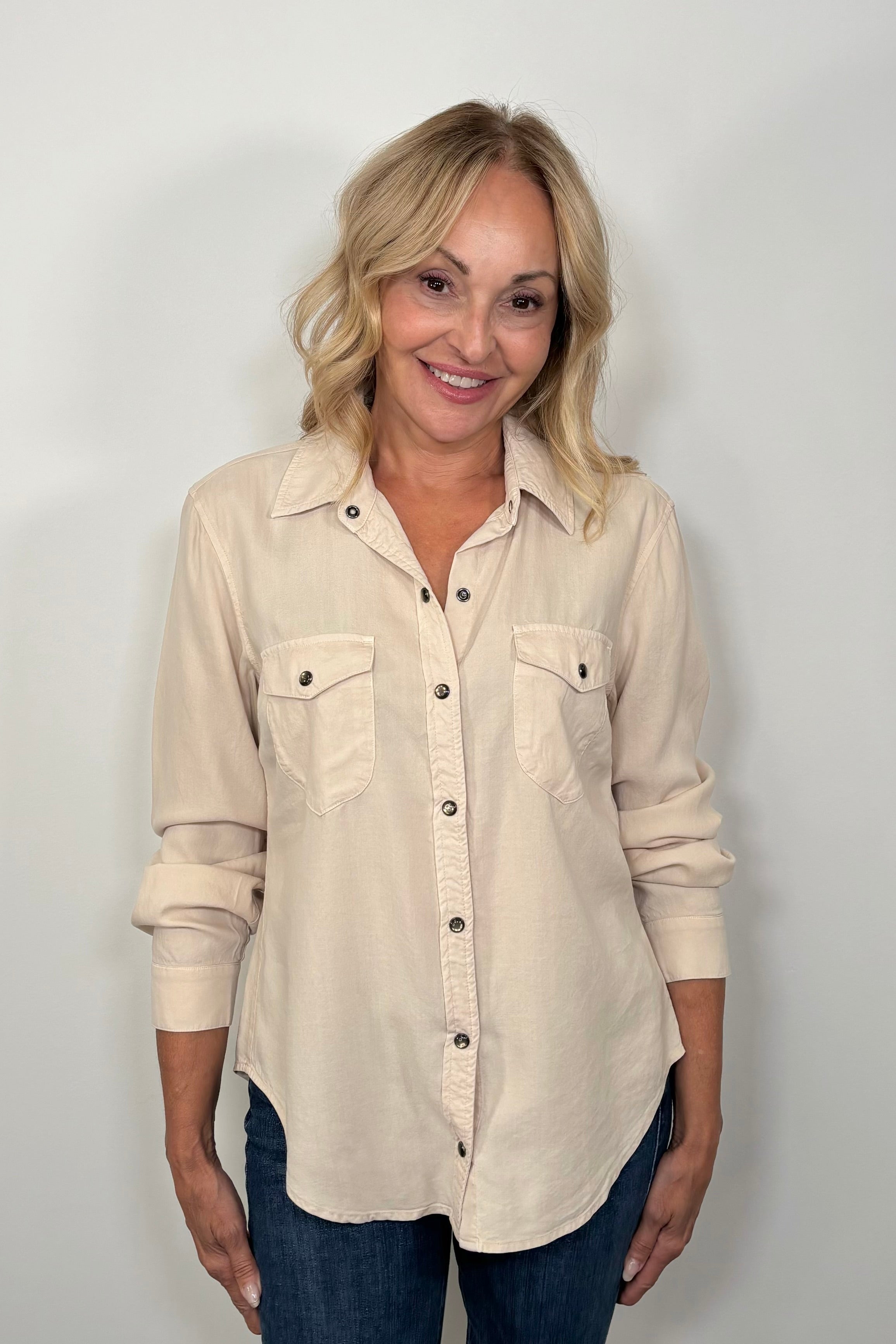 Front view of woman wearing a western snap off-white shirt 