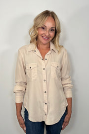 Front view of woman wearing a western snap off-white shirt 
