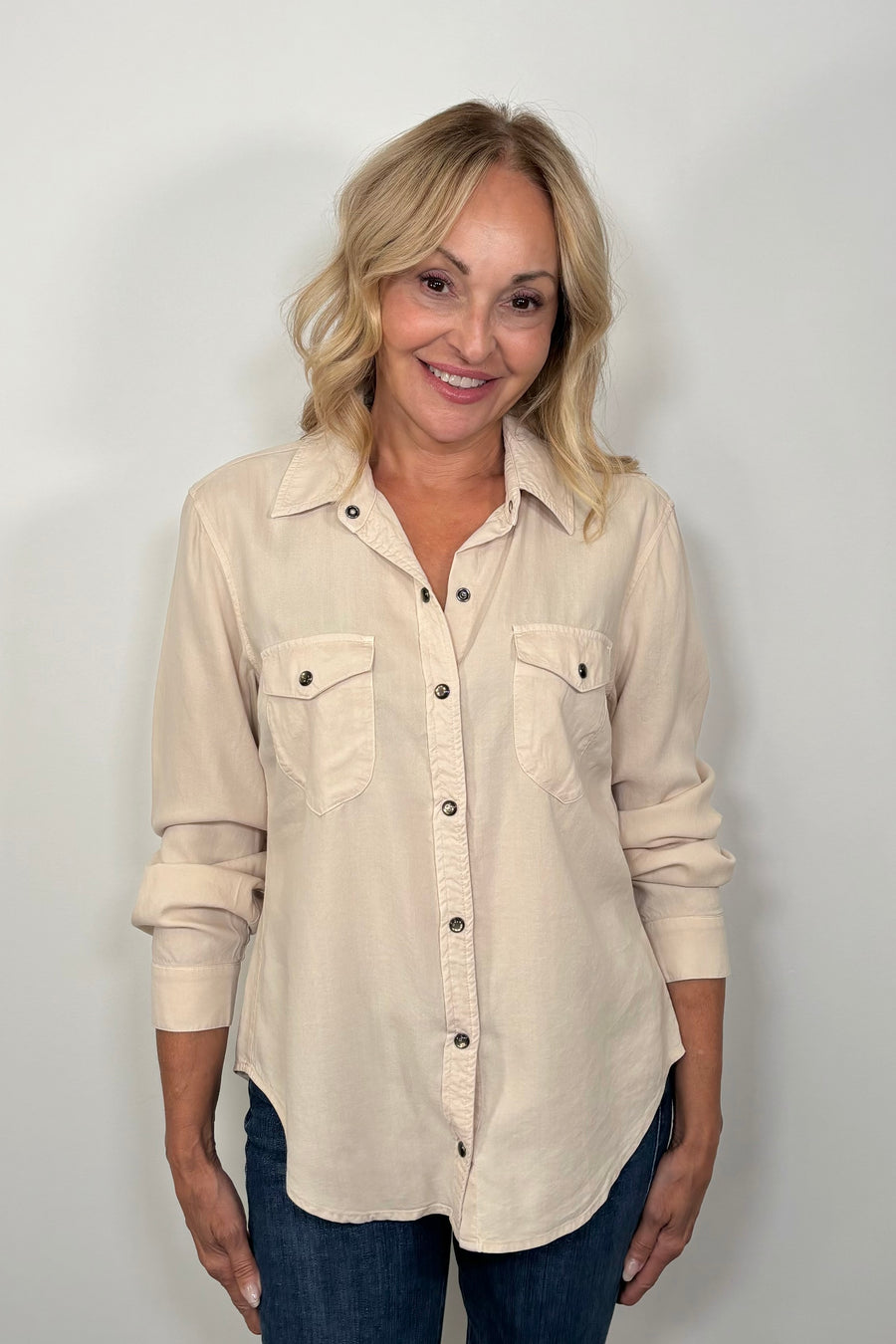 Front view of woman wearing a western snap off-white shirt 