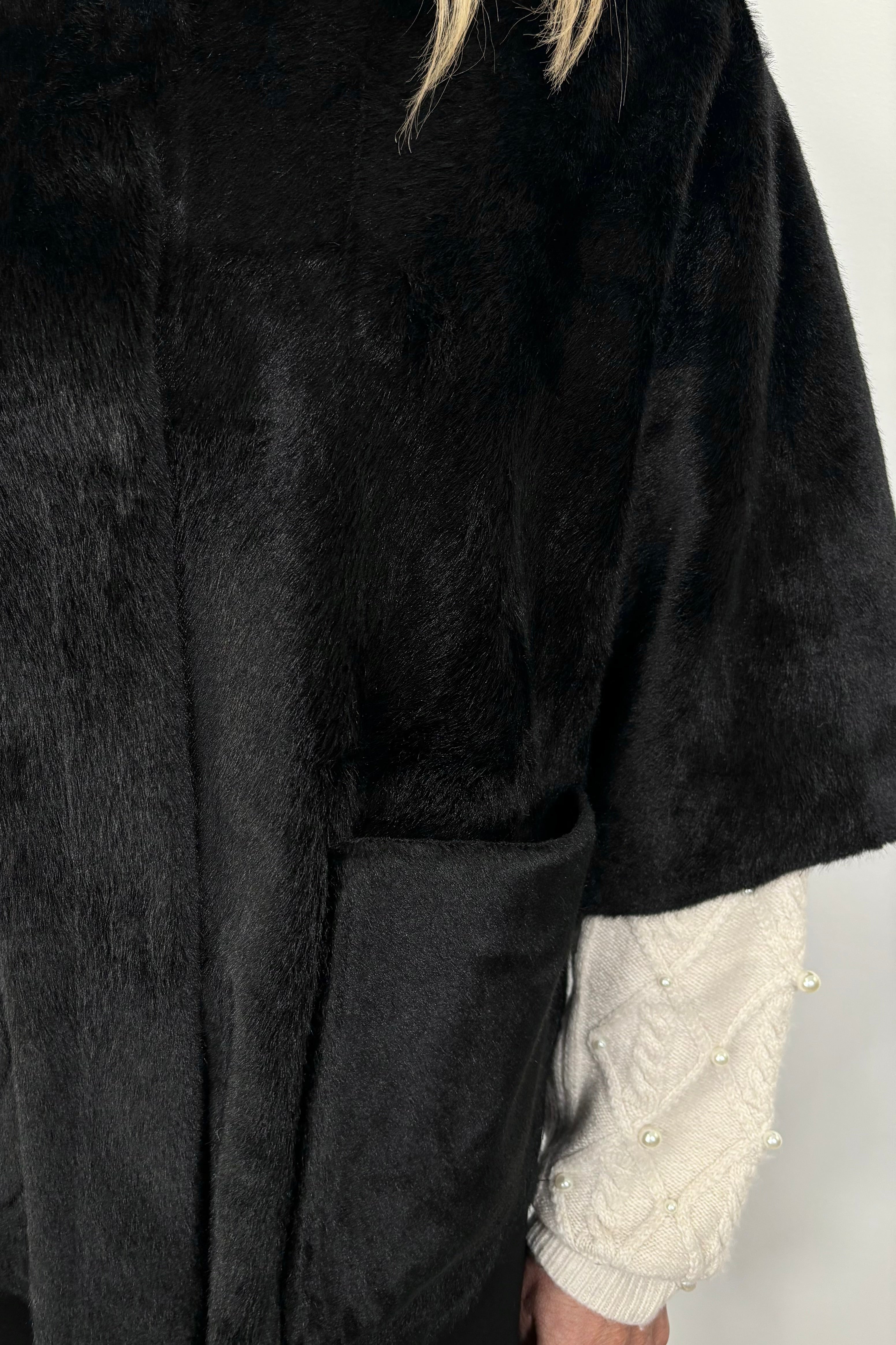 close-up of a black short cape