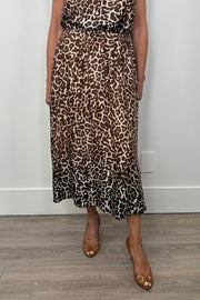 Front view of a woman wearing a gathered leopard print long skirt