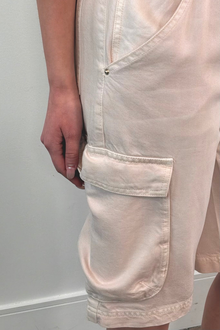 Close-up of light pink cargo shorts