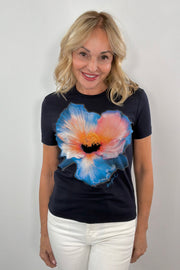 woman wearing a short sleeve navy tee with a flower print