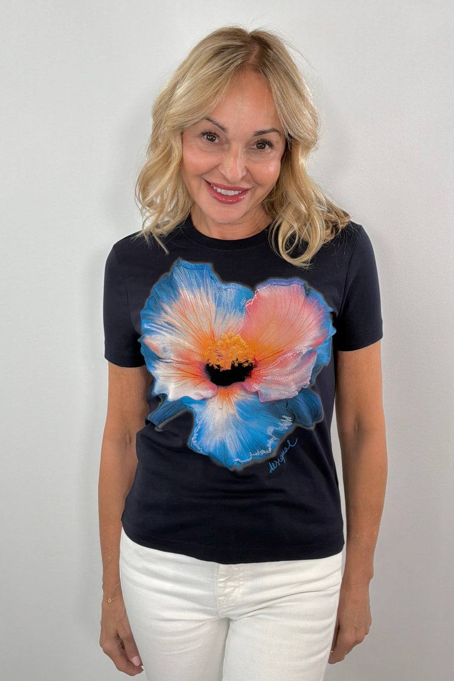 woman wearing a short sleeve navy tee with a flower print