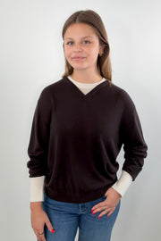 Woman wearing a brown and ivory sweater 