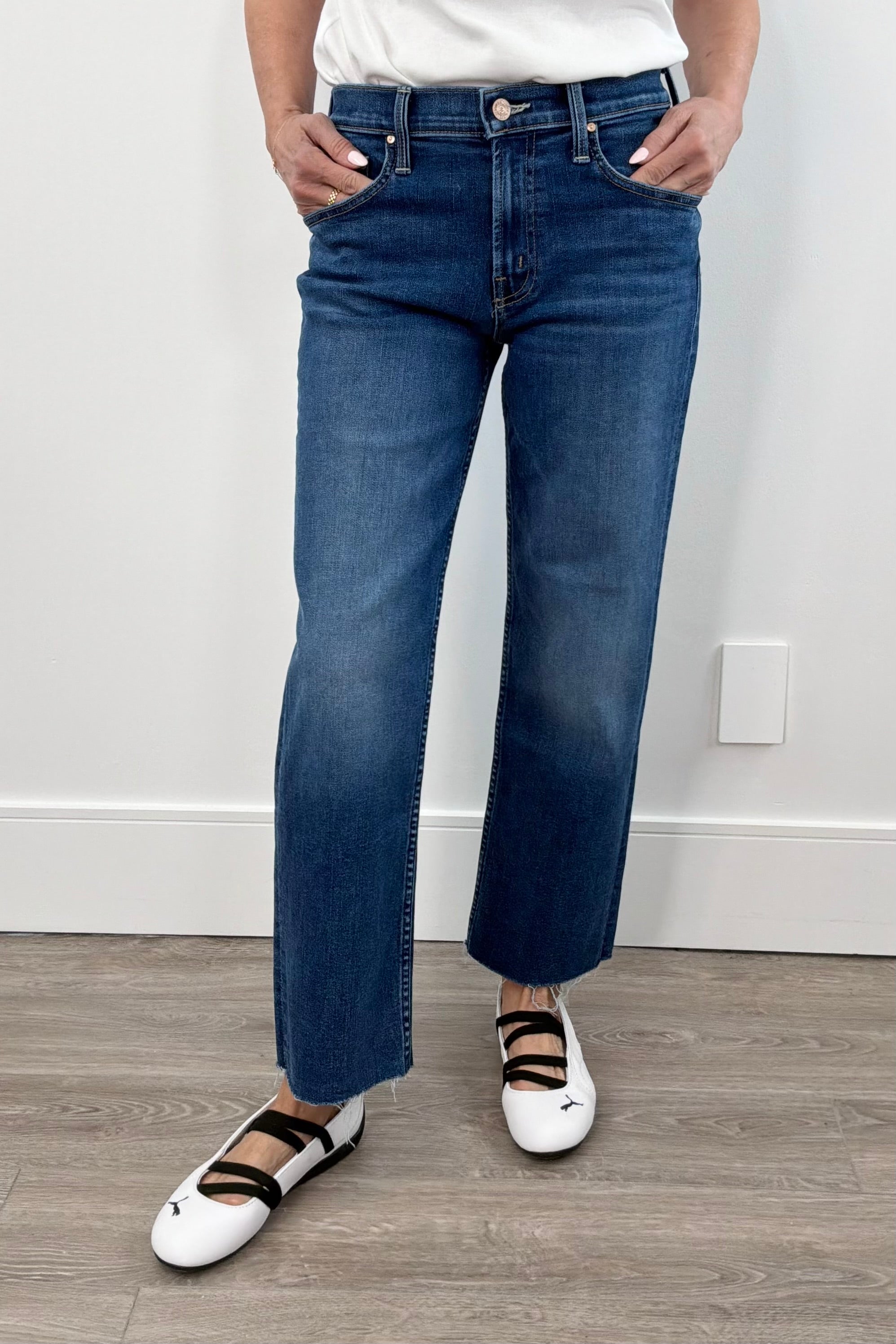 Woman wearing a dark indigo wash ankle length denim