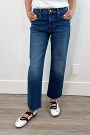 Woman wearing a dark indigo wash ankle length denim