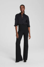 Person wearing a black outfit on a white background