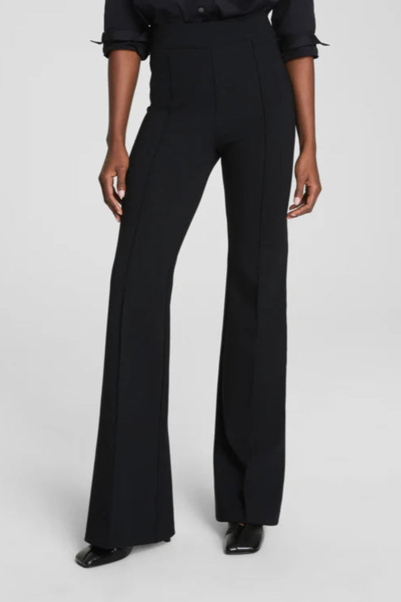 Black pants worn by a person on a white background
