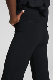 Black pants worn by a person on a light gray background