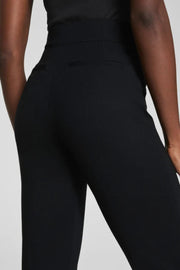 Black pants worn by a person on a light gray background