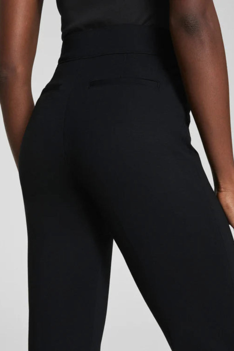 Black pants worn by a person on a light gray background