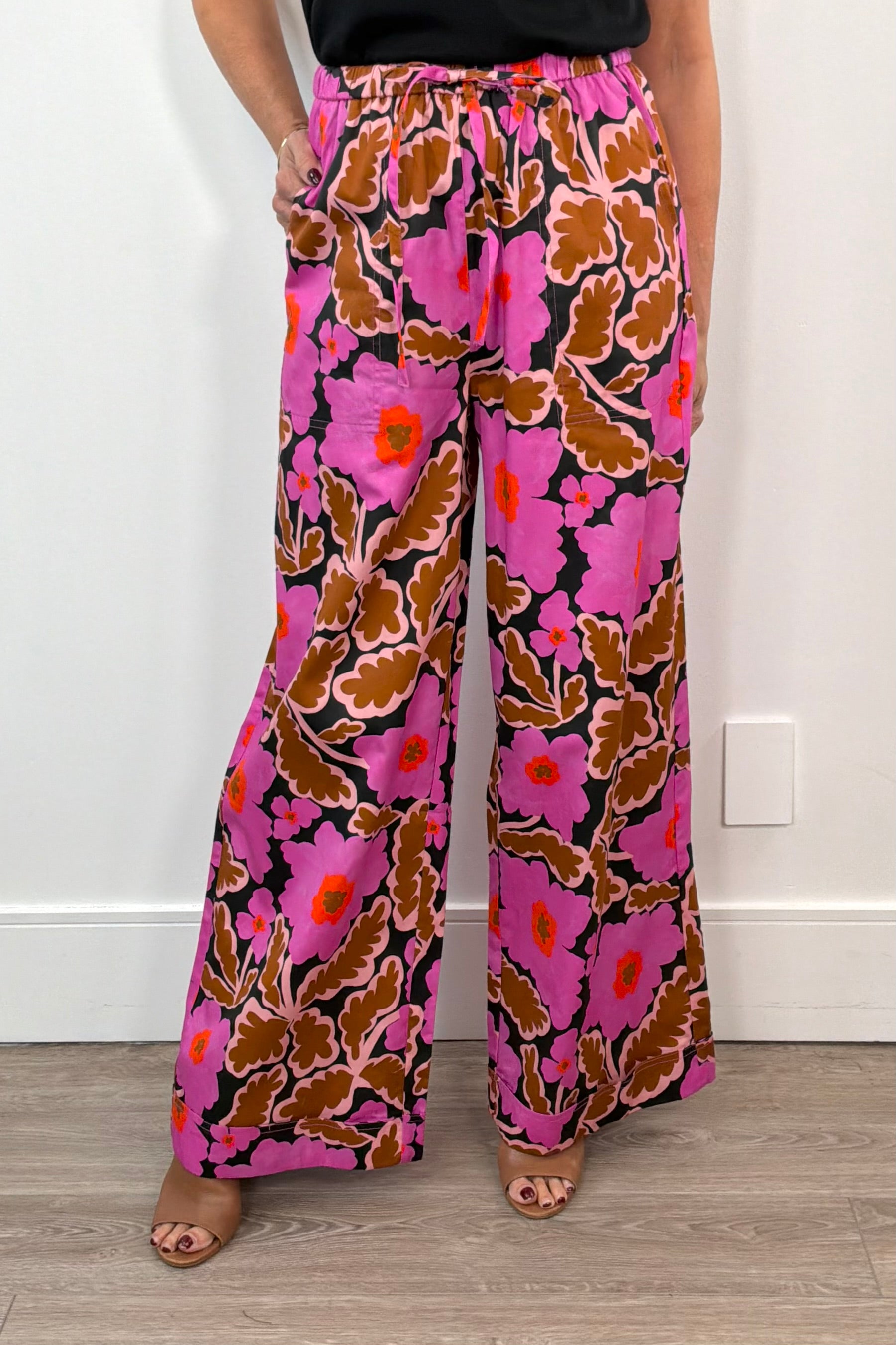 woman wearing wide leg neon pink floral pants