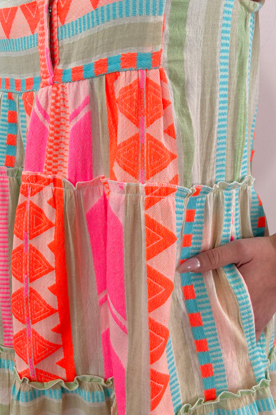 Closeup of woman wearing a bright colorul dress