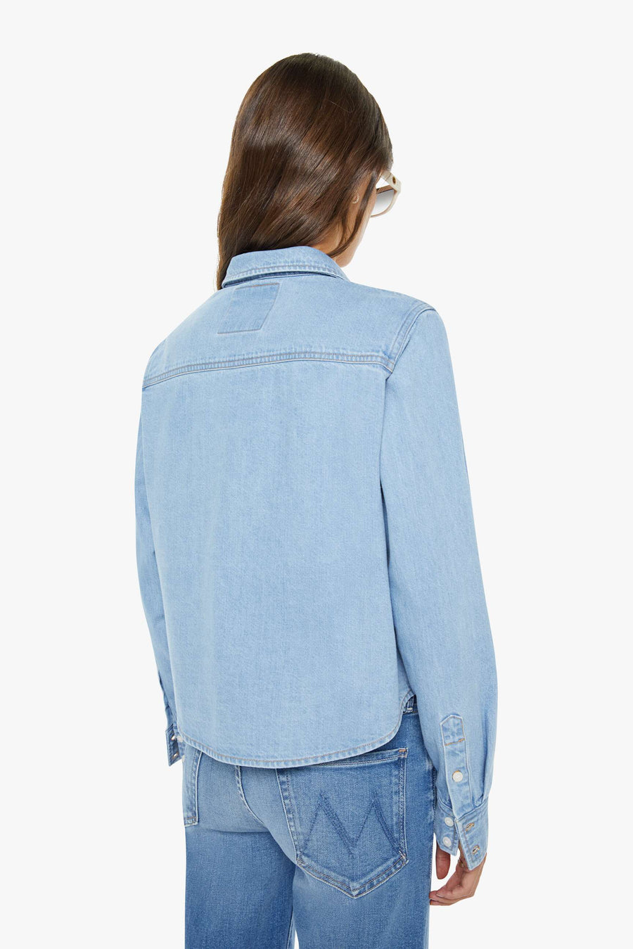 back view of light wash denim collared button up with side pocket