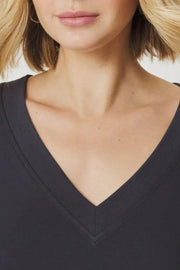 Woman wearing a v neck tee shirt in dark grey Close up