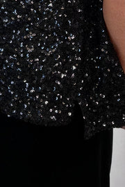 close-up of an oversized black sequin top 