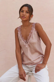 woman wearing a blush sleeveless camisole with lace trim, front