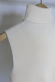 close up of the neck of a cream knitted turtle neck tank top