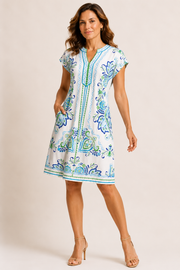 Woman wearing a white patterned shortsleeved dress