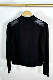 Back view of a black coloured mix media bomber jacket 