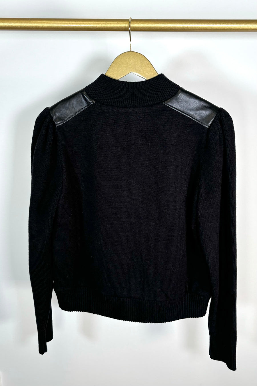Back view of a black coloured mix media bomber jacket 