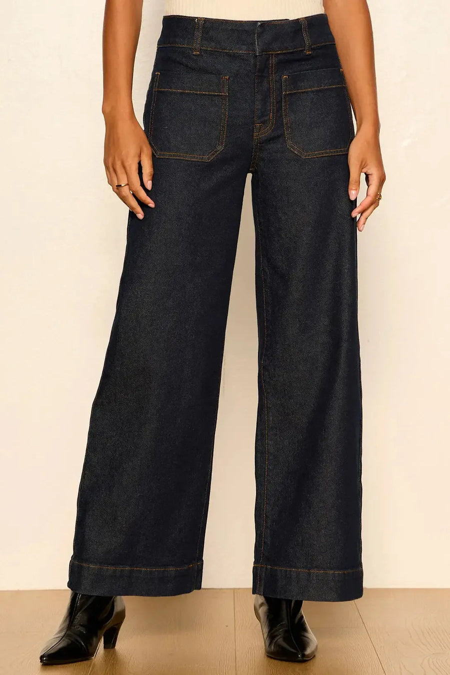 model wearing dark wash wide leg jeans with front pockets 