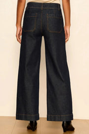 model wearing dark wash wide leg jeans with front pockets 