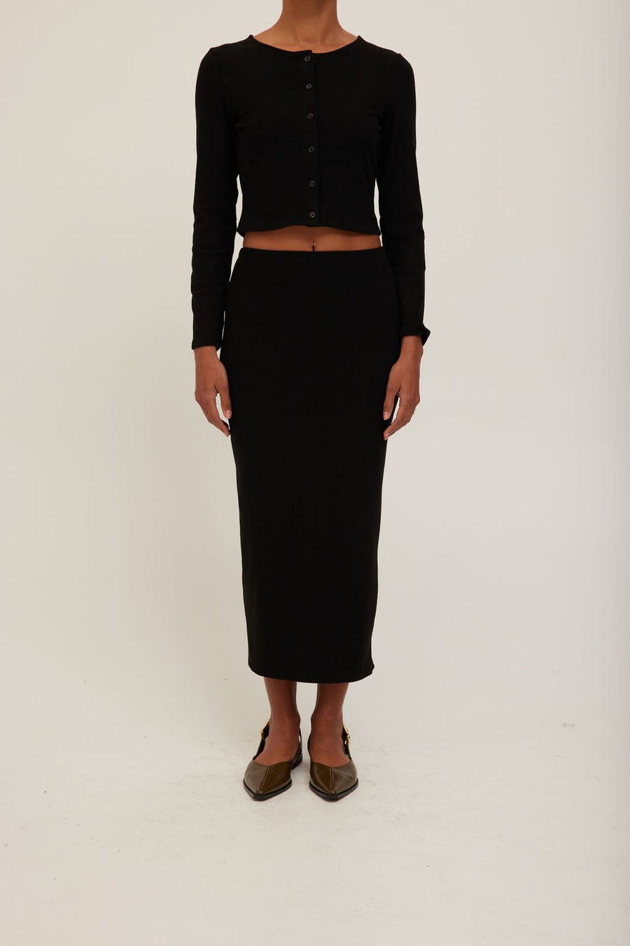 women wearing a midi knit black skirt