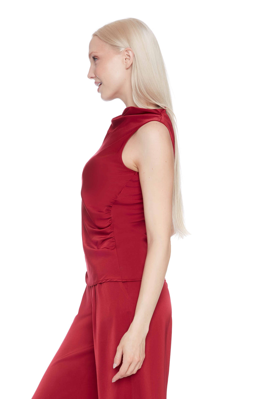Woman wearing a red satin top on a white background
