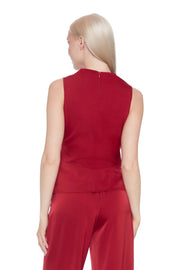 Woman wearing a red satin top on a white background