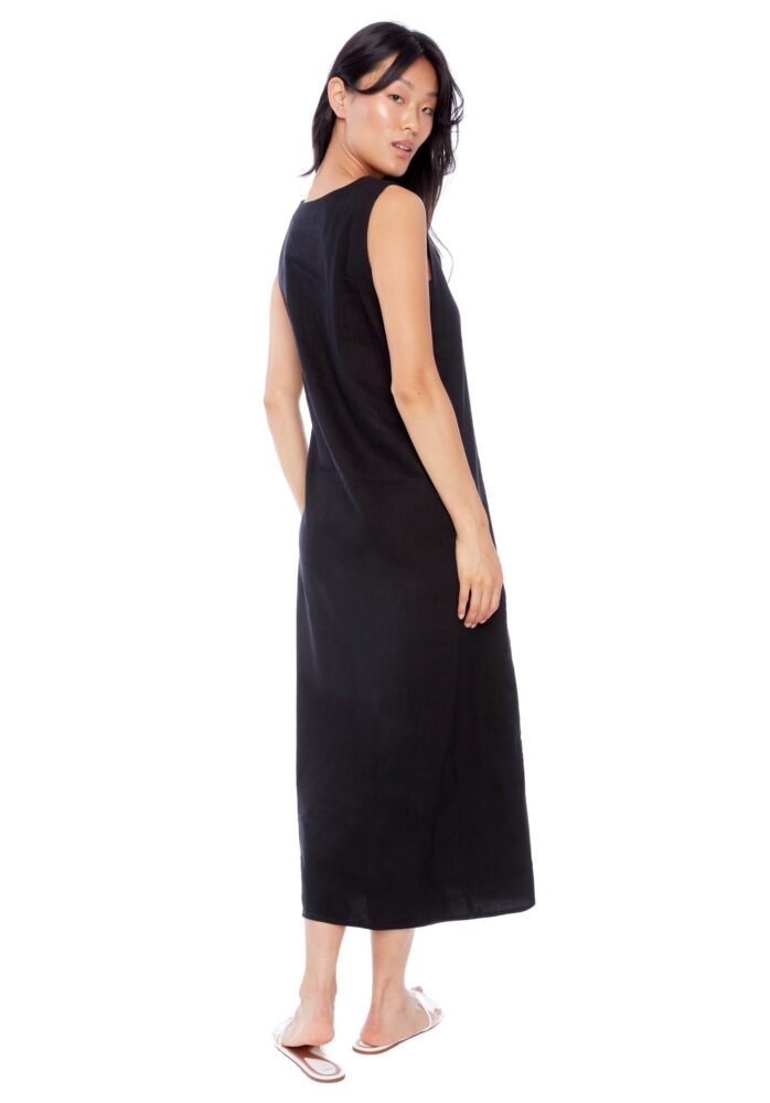 Woman wearing a black sleeveless dress on a white background