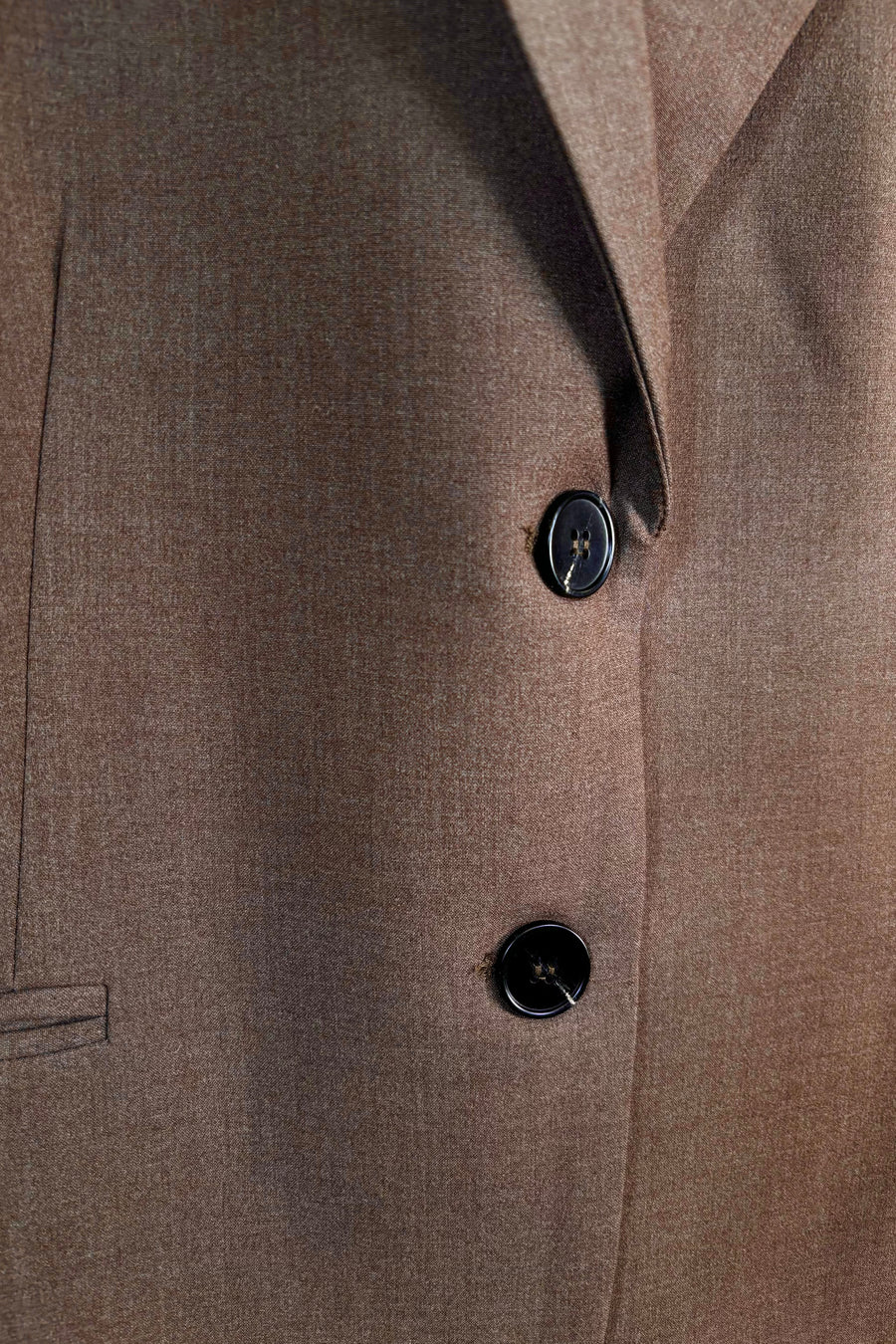 Zoom in of a closed cool brown blazer