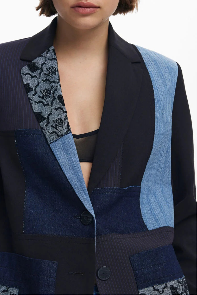 Close-up view view of a woman wearing a multi texture blazer