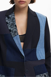 Close-up view view of a woman wearing a multi texture blazer