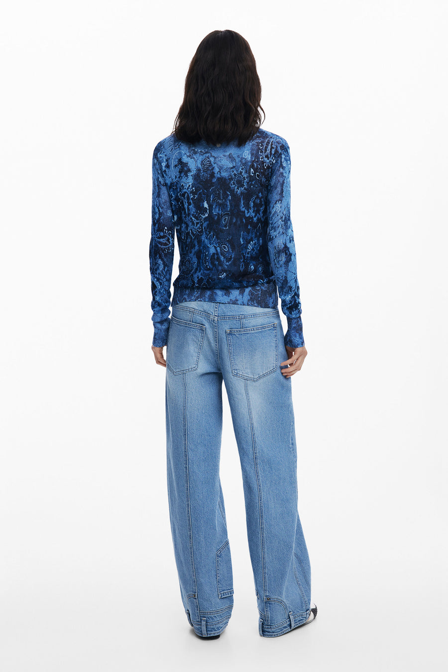 Back view of woman wearing a blue patterned thin cardigan
