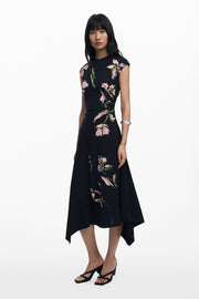 3/4 full body view of woman wearing a asymmetrical floral dress