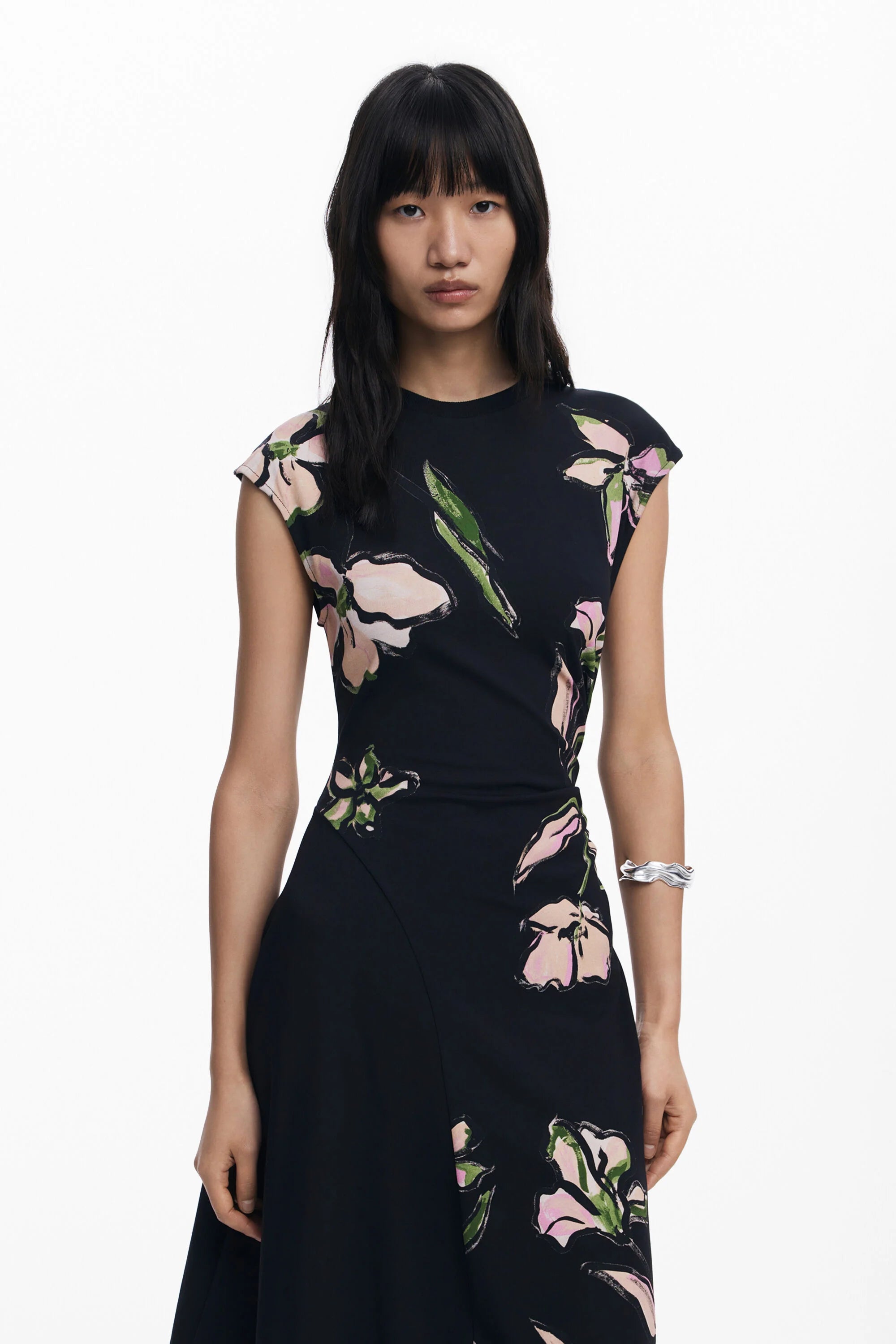 Front view of woman wearing a asymmetrical floral dress