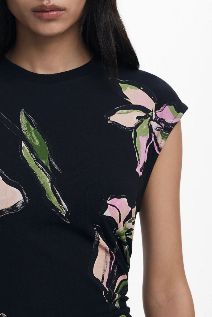 Close-up view of the shoulder of a woman wearing a floral dress